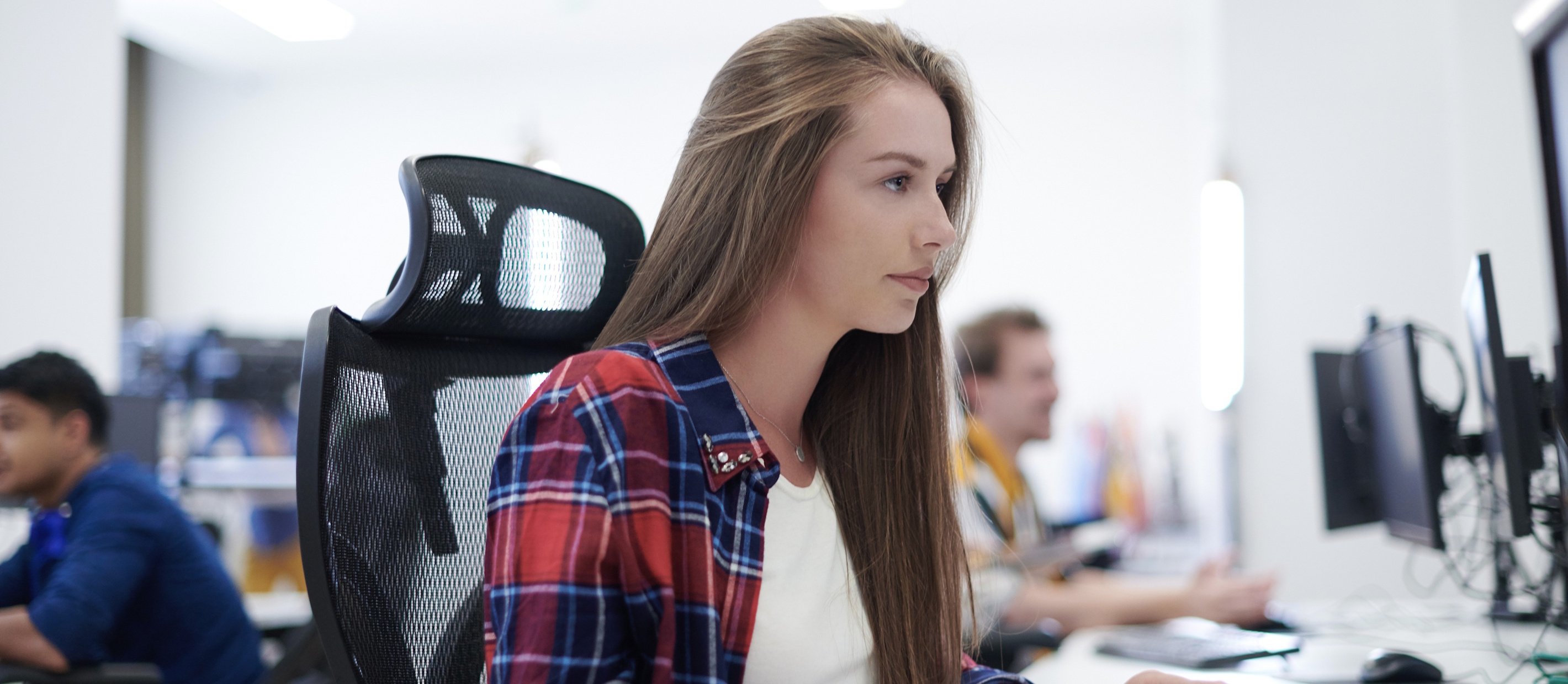 Ung kvinnlig systemutvecklare framför sin dator