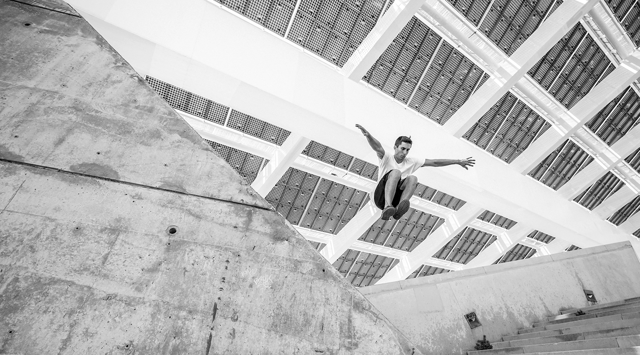 Man som hoppar från en mur